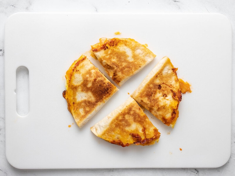 Sliced quesadillas on a cutting board.