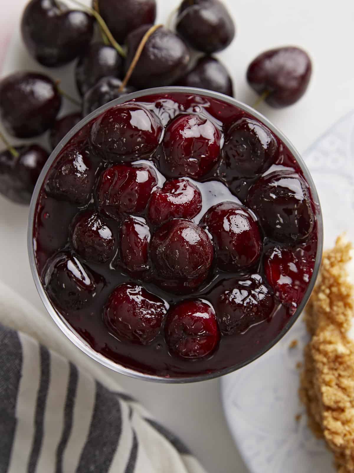 Overhead view of a glass dish full of cherry sauce.