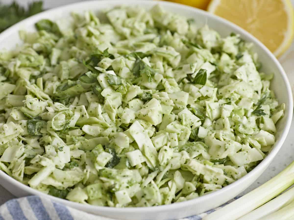 Side shot of Green Goddess Salad in a white bowl.