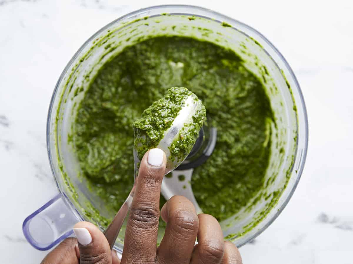 Green vegetable ingredients blended in food processor.