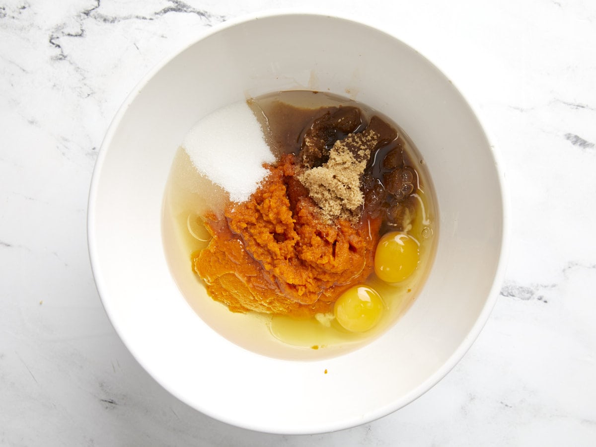 Wet ingredients for pumpkin muffins in a bowl, not stirred together.