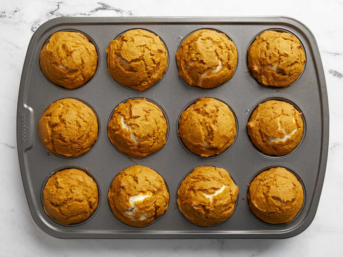 Baked pumpkin muffins in the muffin tin.