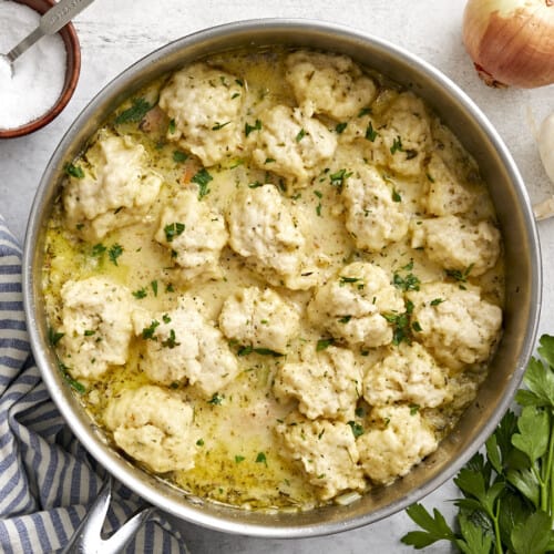 Overhead view of chicken and dumplings in a skillet.