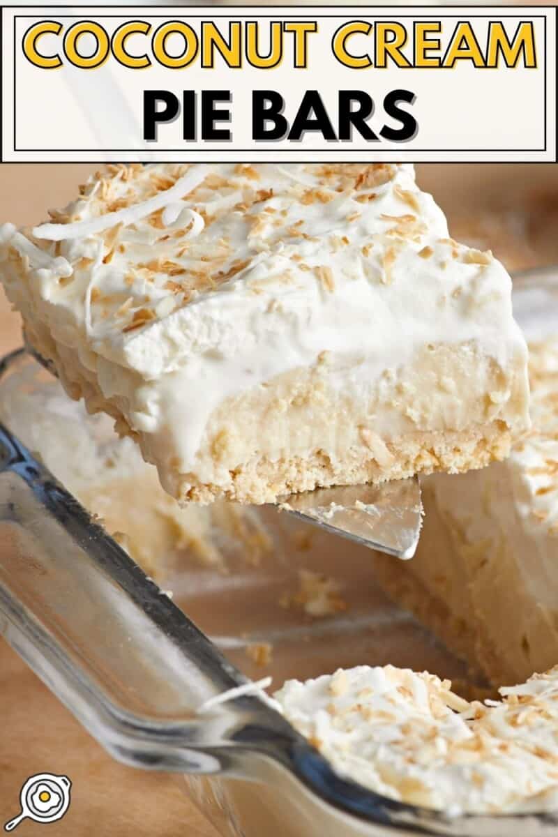 Side view of a slice of coconut cream pie bar being lifted from the baking dish.