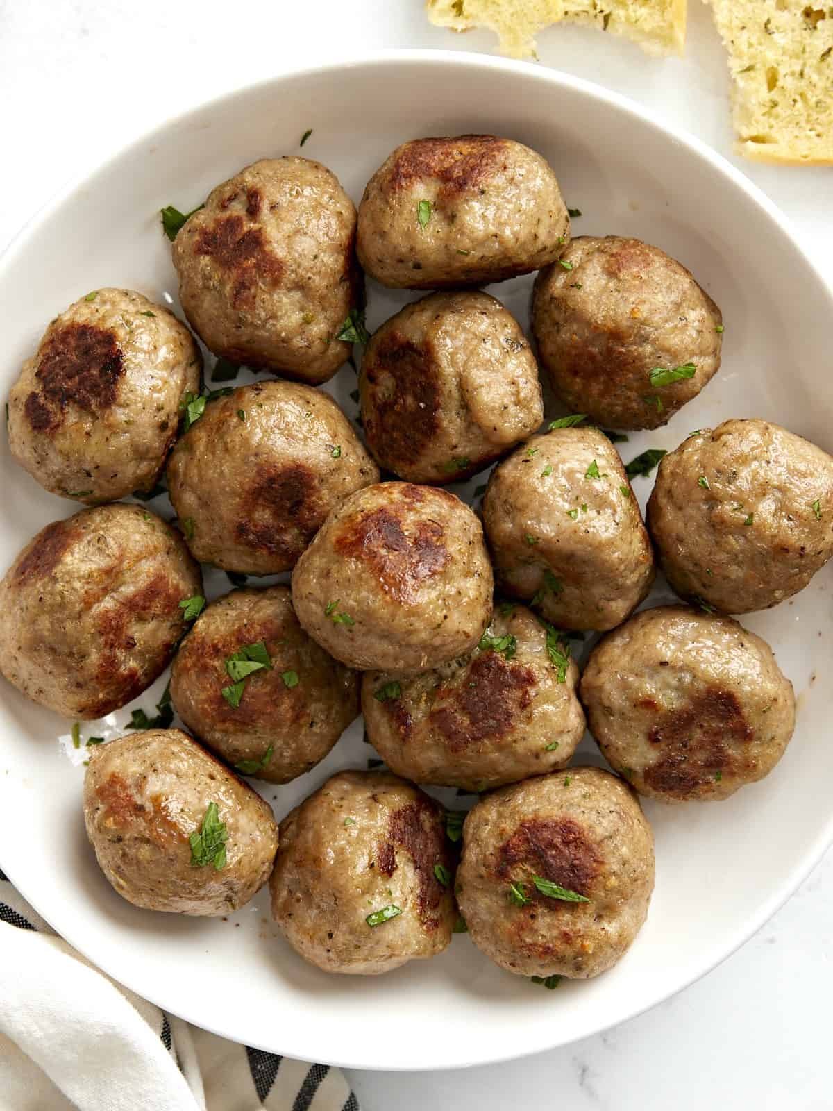 Overhead close up view of turkey meatballs in a bowl, no sauce.