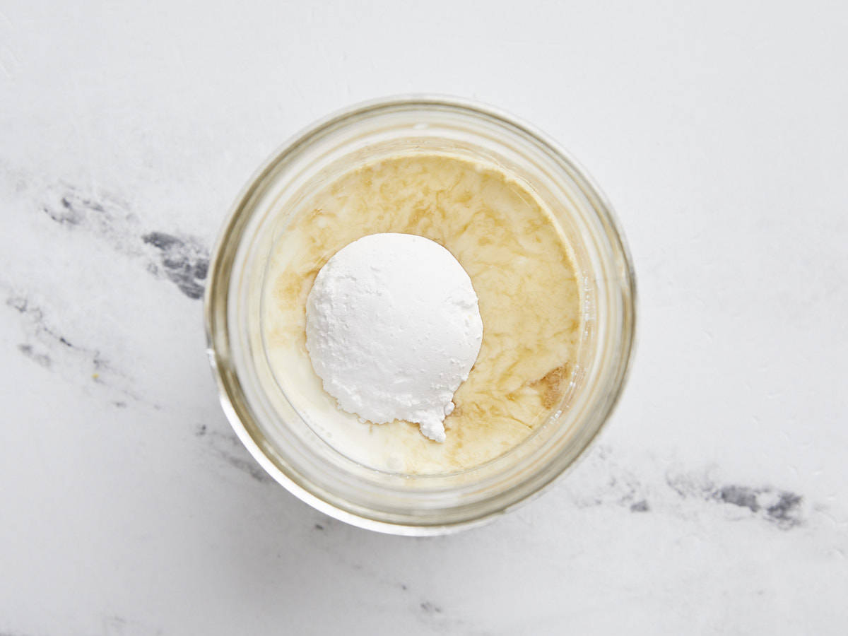 Milk, cream, sugar, and vanilla in a jar.