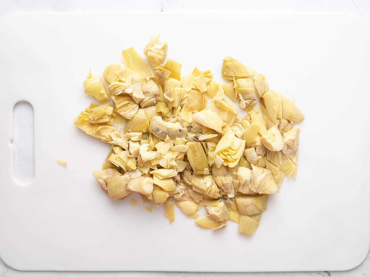 Chopped artichoke hearts on a cutting board.