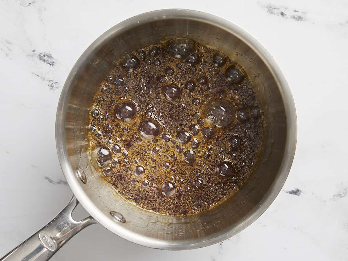 Caramelized sugars boiling in the pot.