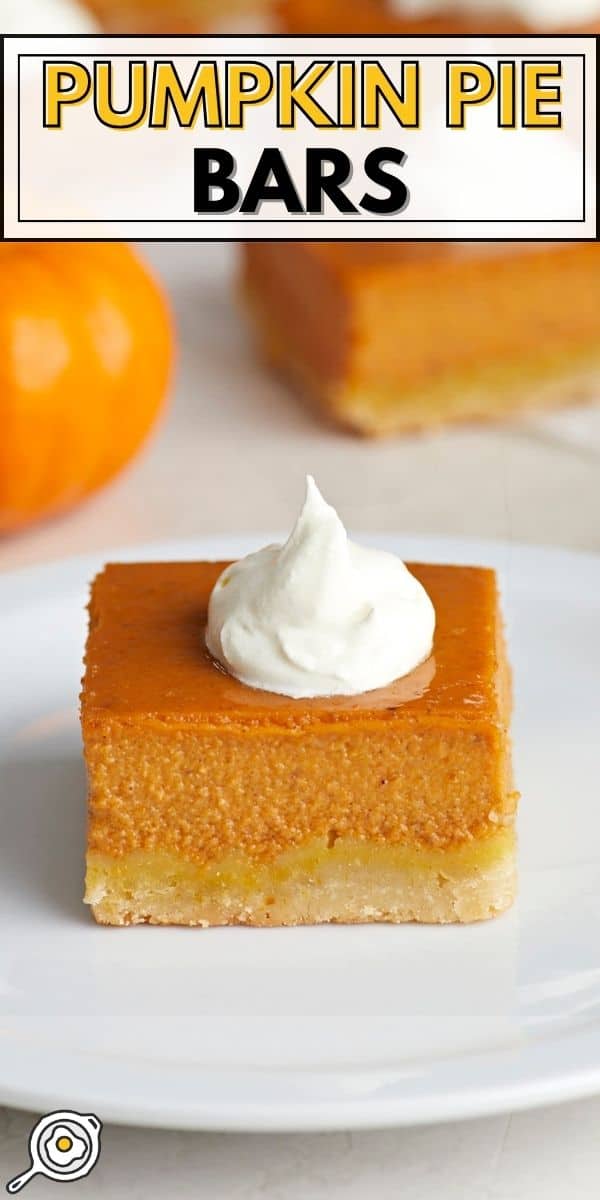 Side view of a pumpkin pie bar on a white plate with whipped cream on top.