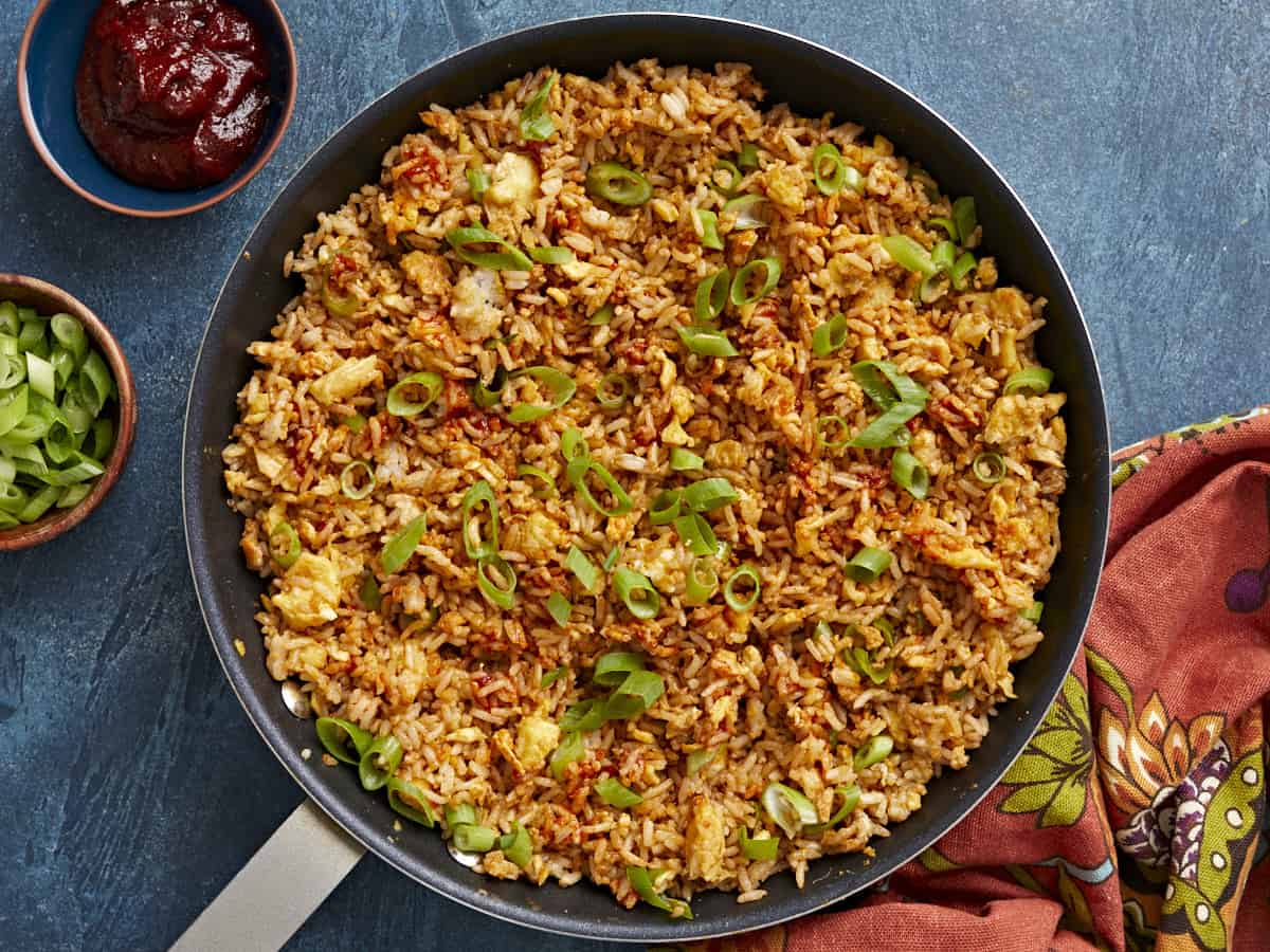 Overhead view of scrambled eggs with rice in the skillet.