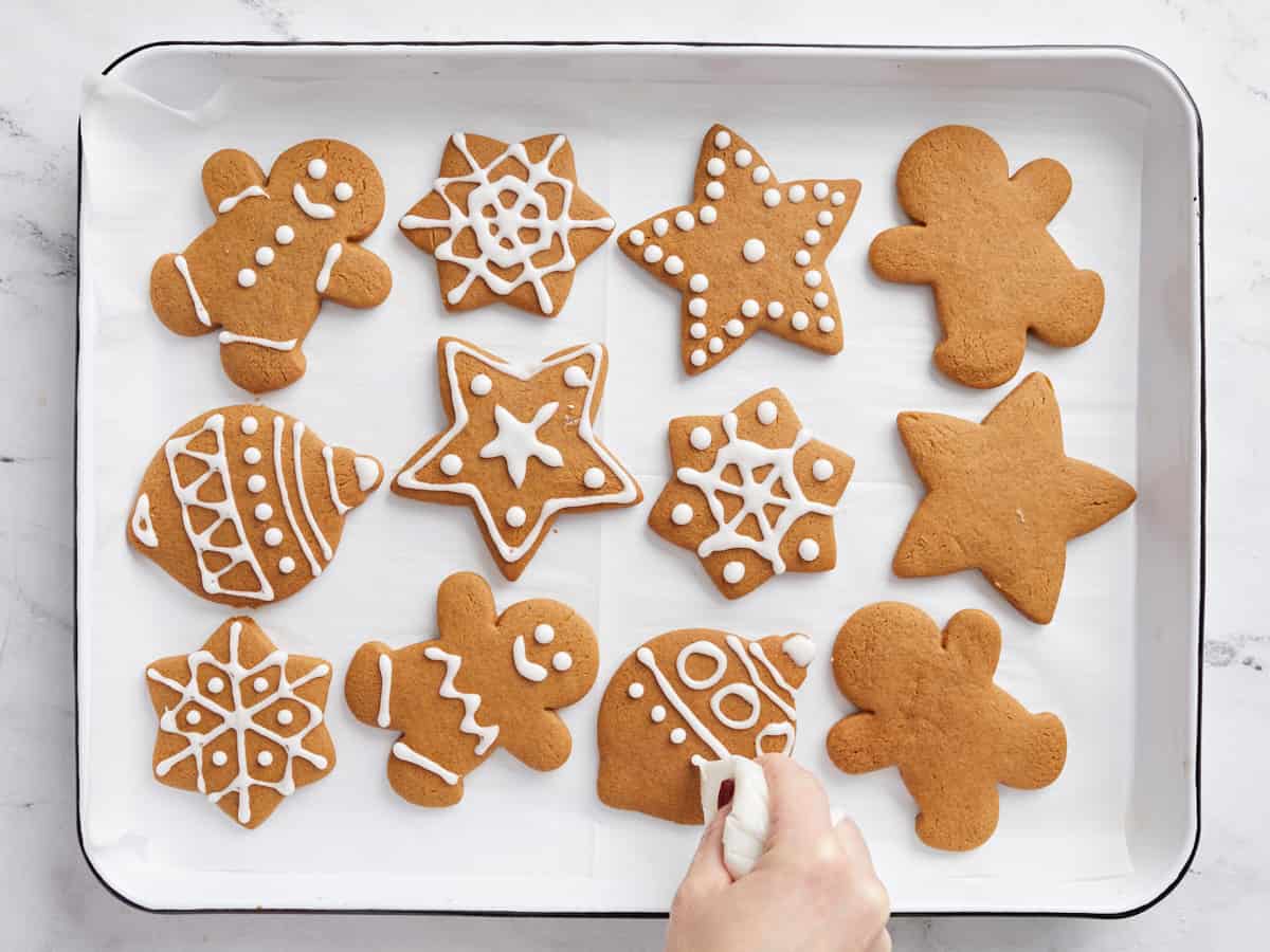 Cookies being decorated with icing. 