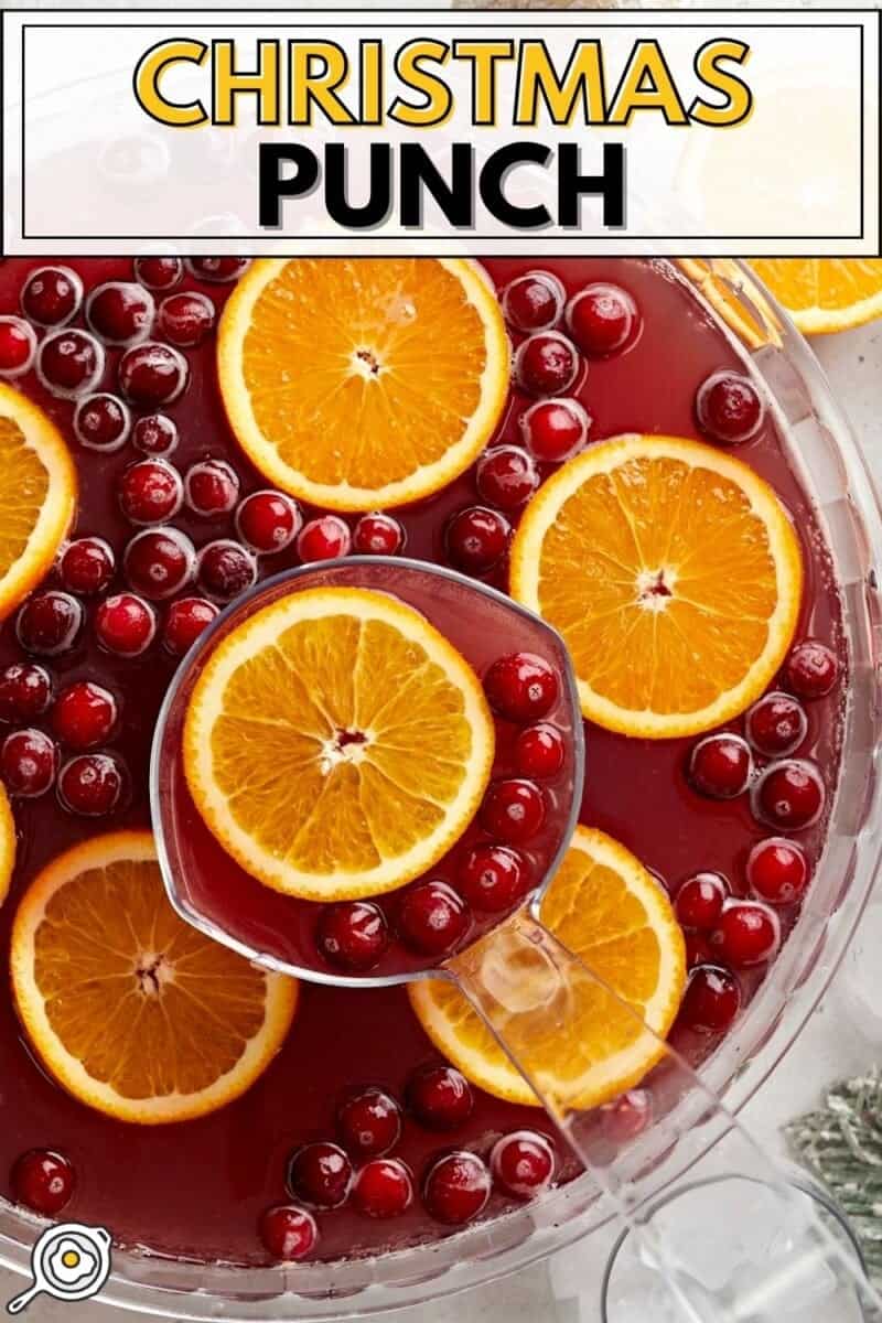 Close up overhead view of a punch bowl full of Christmas Punch with a ladle.