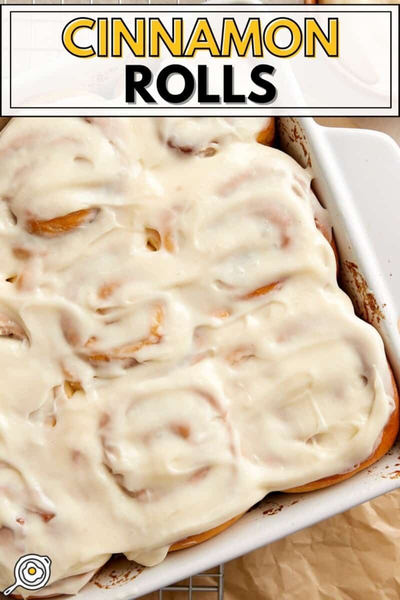 Overhead view of cinnamon rolls in a baking dish with cream cheese icing.