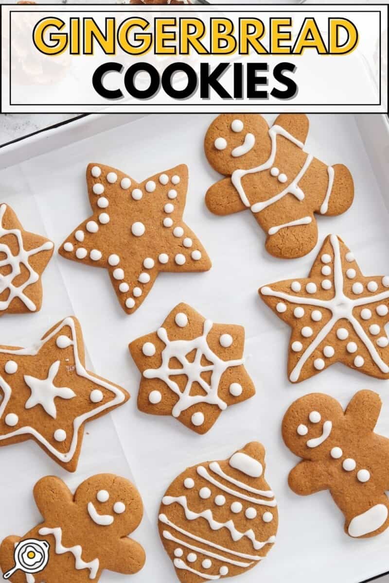 Overhead view of decorated gingerbread cookies on a baking sheet.