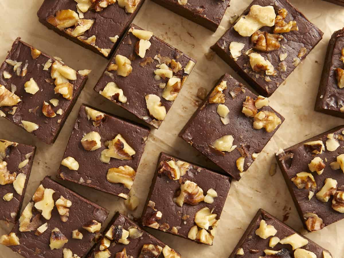 Sliced chocolate fudge on a wooden background.