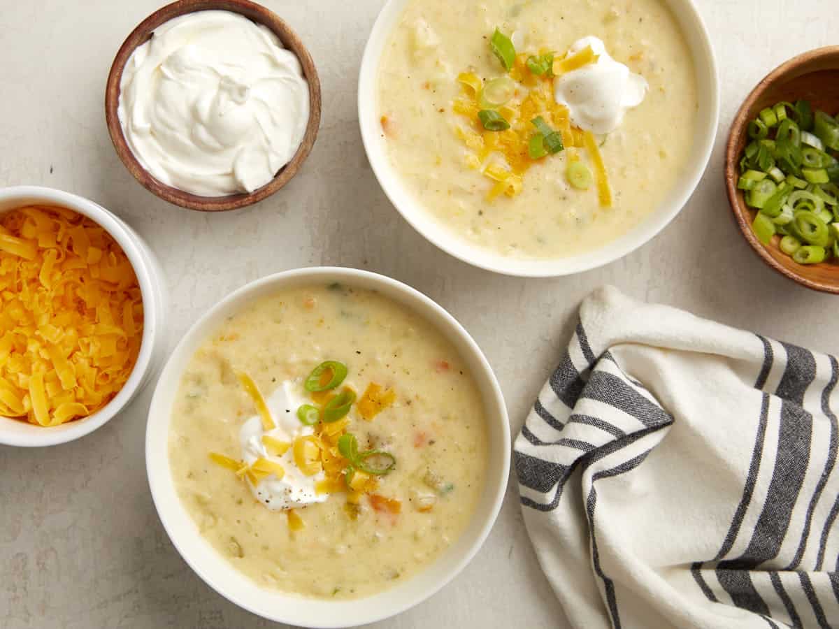 Overhead view of two bowls of slow cooker potato soup.