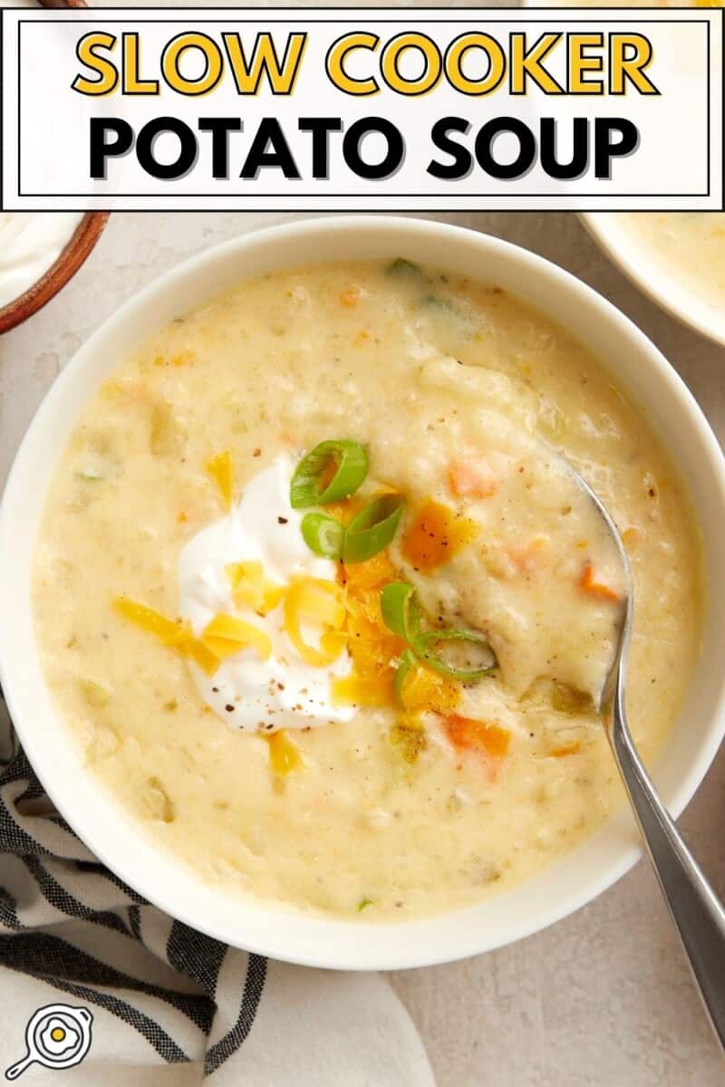 Overhead view of slow cooker potato soup in a white bowl with a soup on the side and title text at the top.