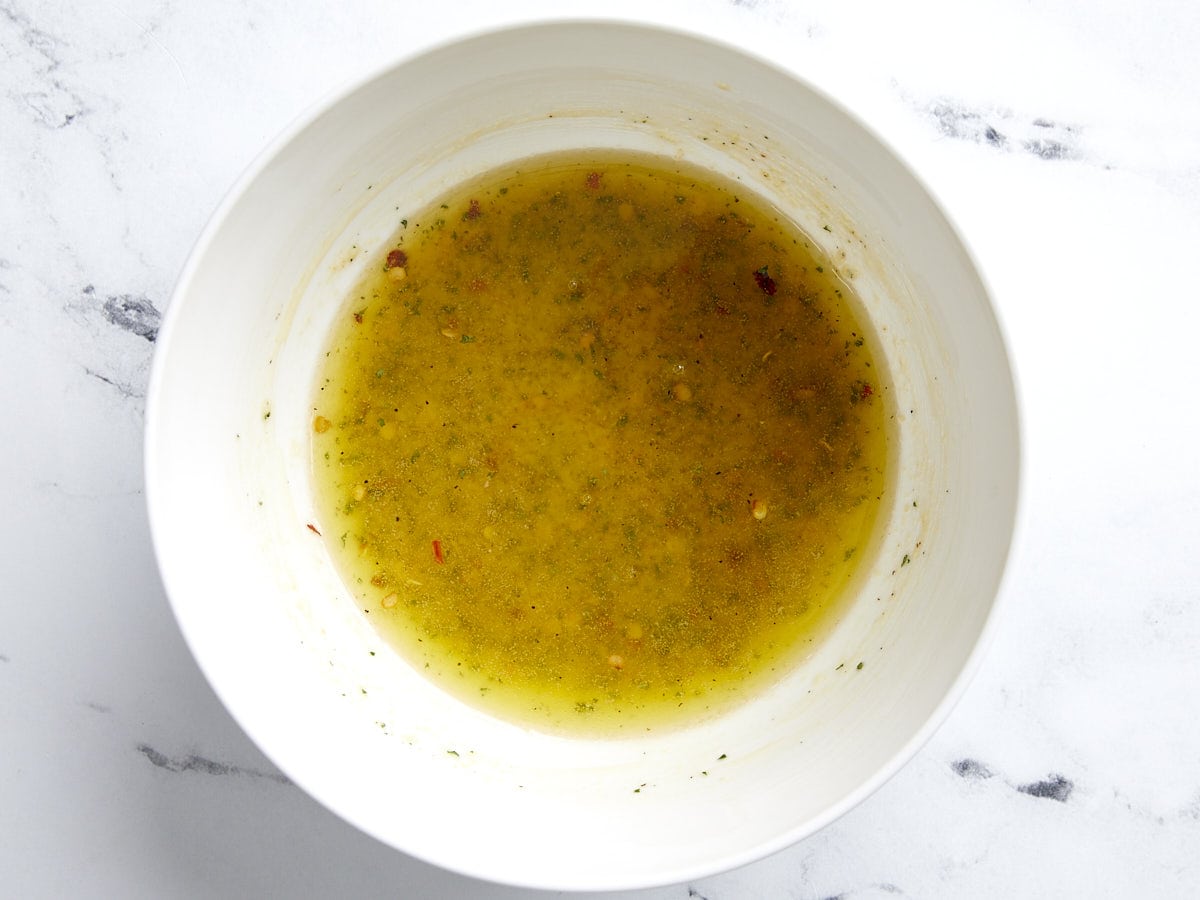 Melted butter, ranch seasoning and spices in a bowl.