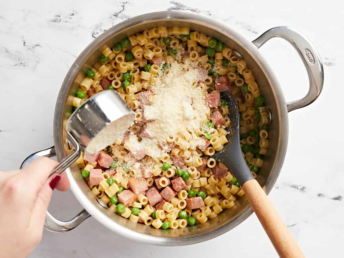 Parmesan being sprinkled over the pasta.