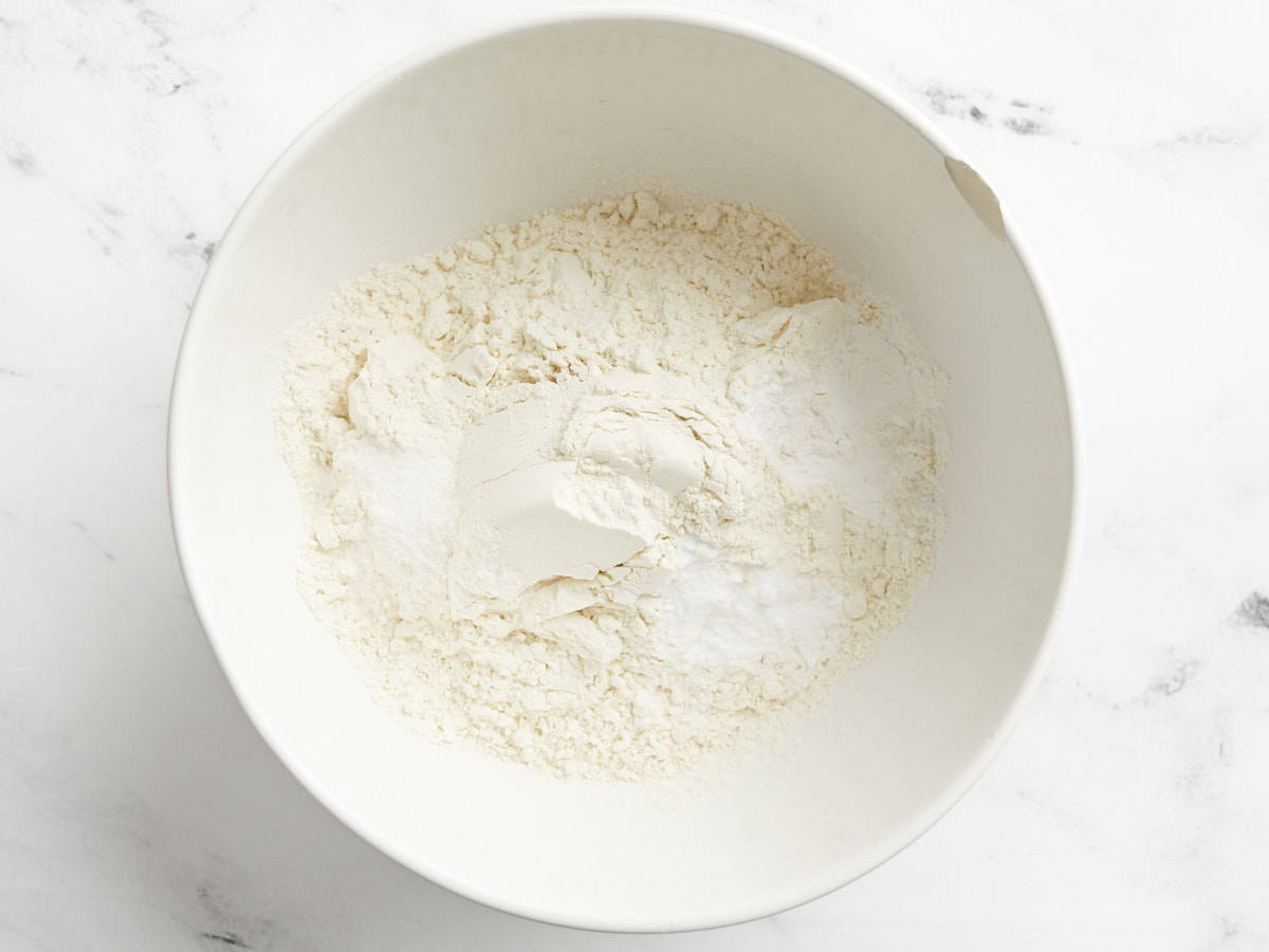 Dry ingredients for cranberry orange bread in a bowl. 