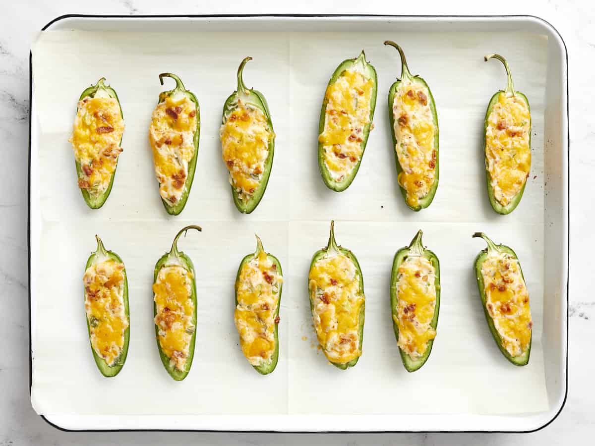 Baked jalapeño poppers on the baking sheet. 