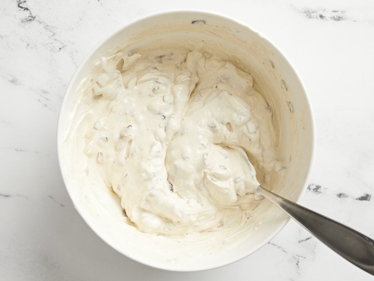 Finished caramelized onion dip in the bowl with a spoon. 