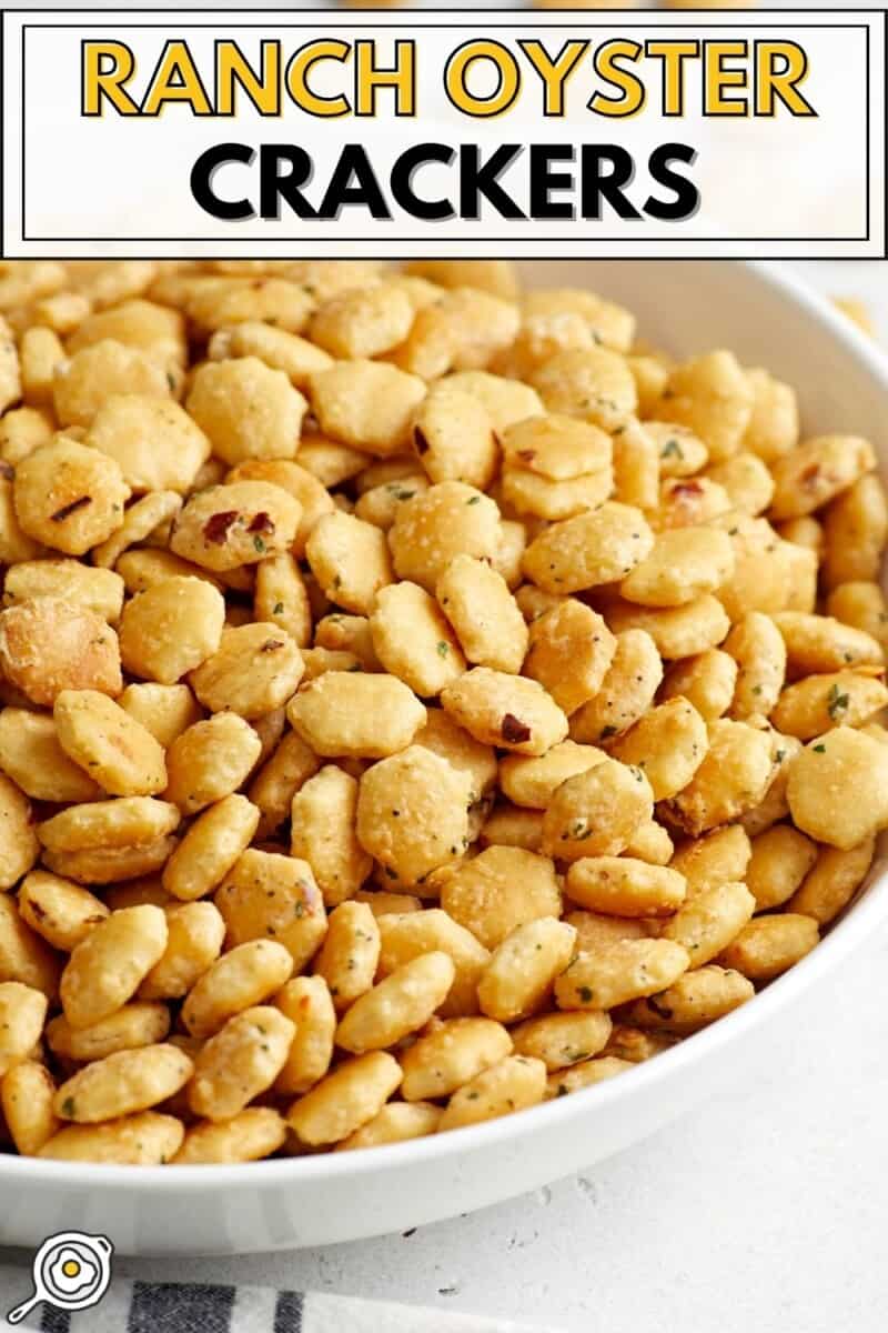 Side close up view of ranch oyster crackers in a white serving dish with title text at the top.