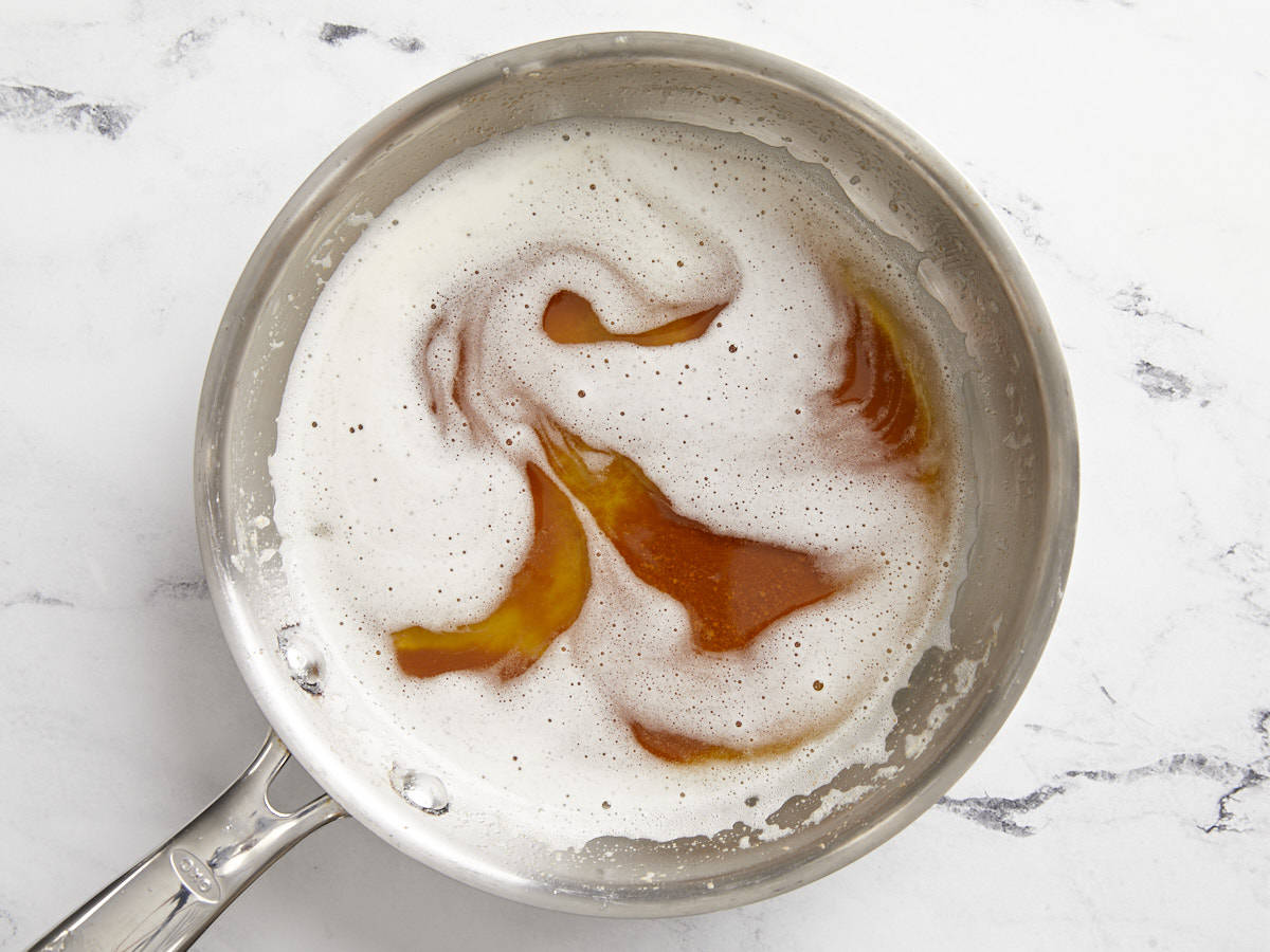 Overhead view of browned butter in a saucepan.