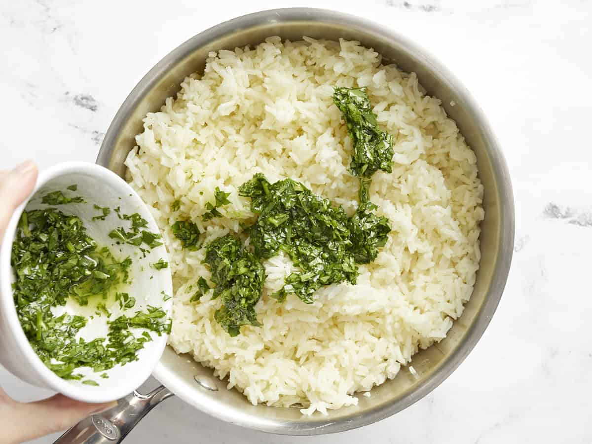 Cilantro lime mixture being poured into the rice.