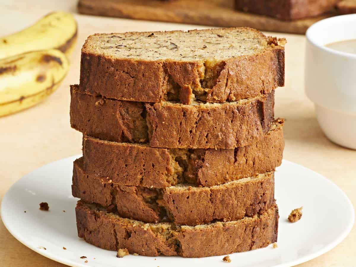 Stacked slices of banana bread on a plate. 