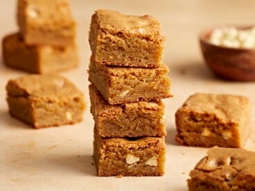 Side close up view of four blondie bars stacked on top of each other.