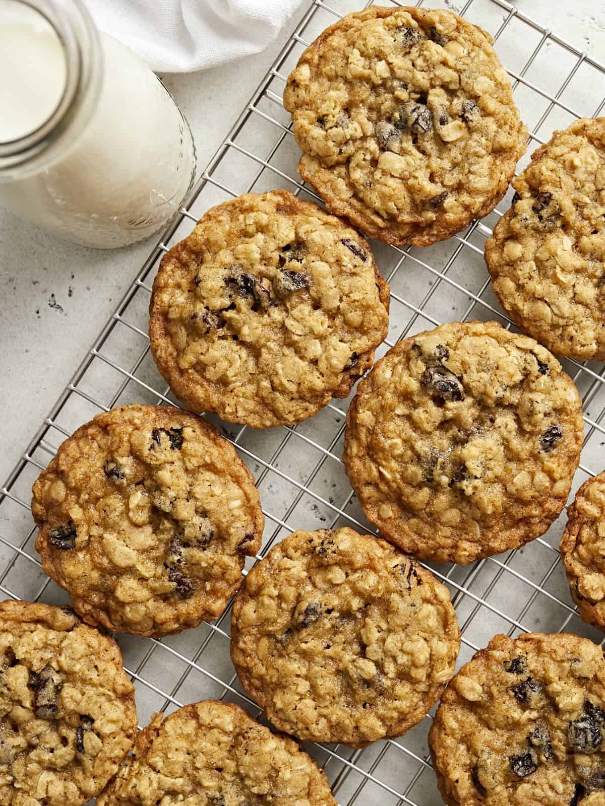 Overhead view of oatmeal raisin cookies on a cooling rack.