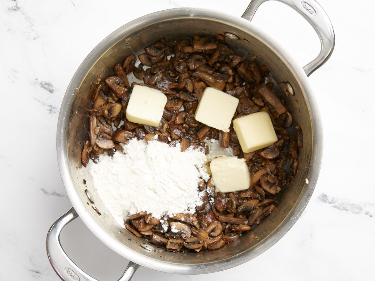 Flour and butter added to the soup pot with the mushrooms. 