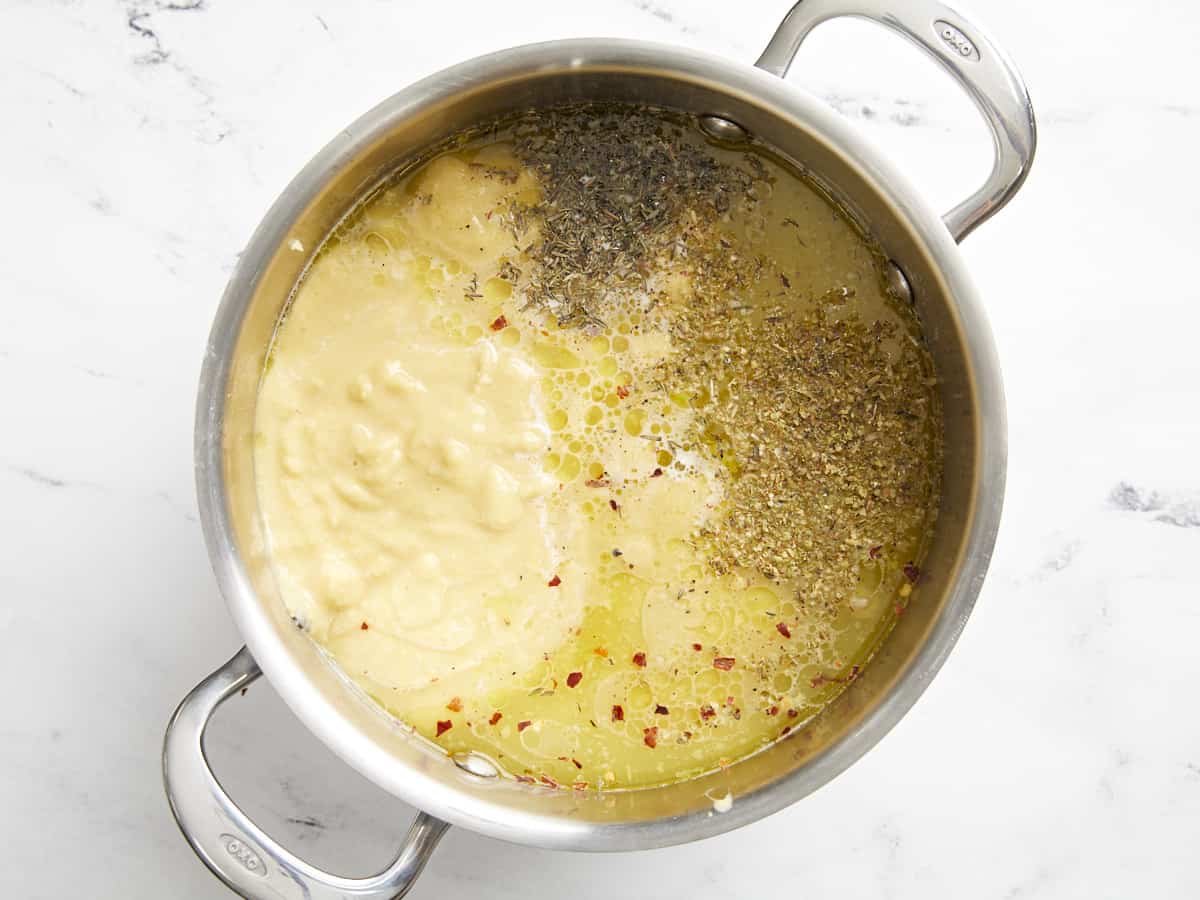 Beans, broth, and herbs in the soup pot.