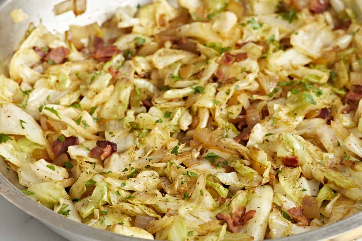 Close up side view of fried cabbage in the skillet.