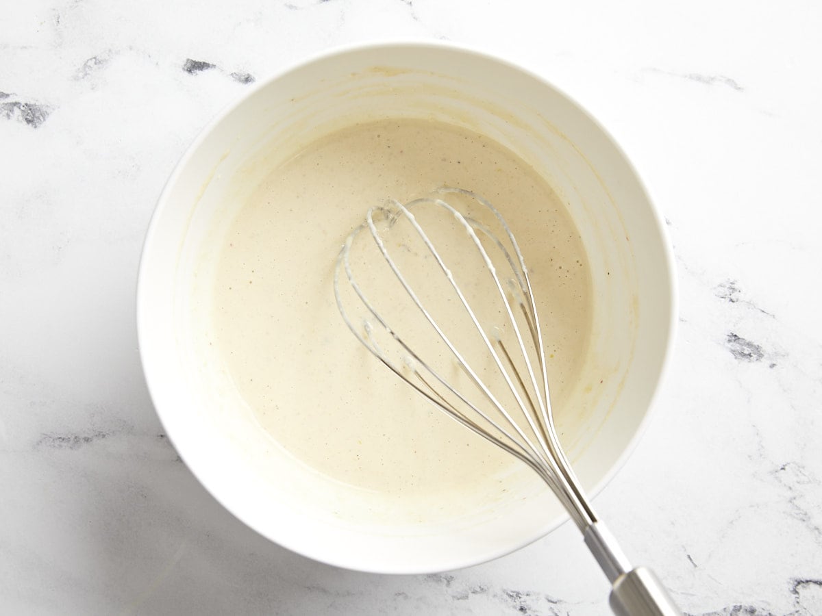 Fully mixed Caesar dressing in a bowl.