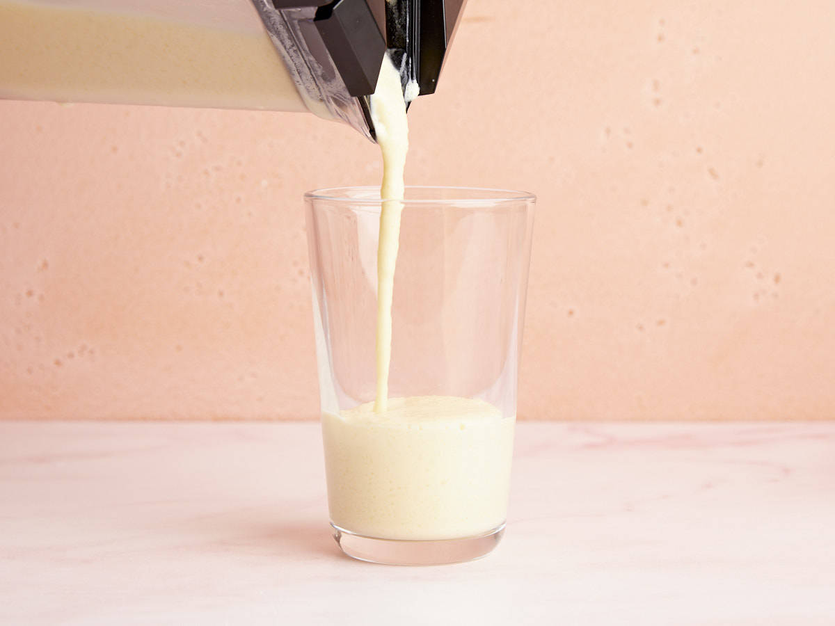 Orange Julius being poured from the blender into a glass. 