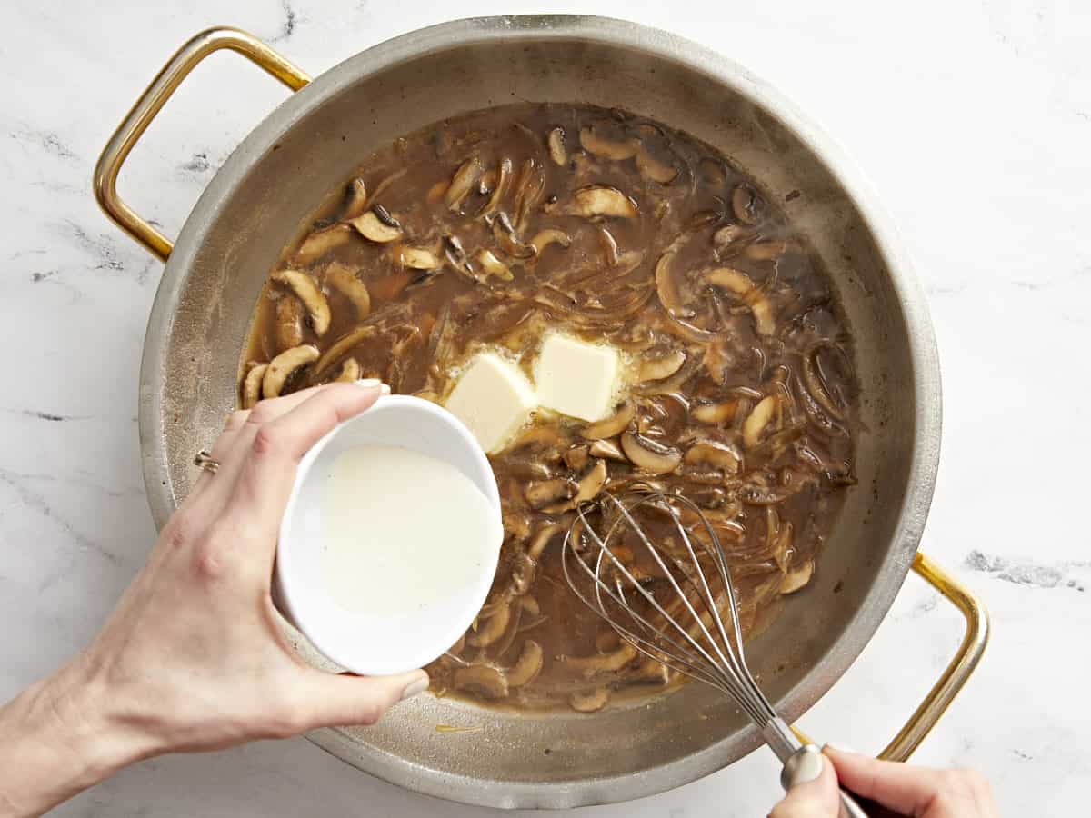 butter added to marsala sauce in a pan.