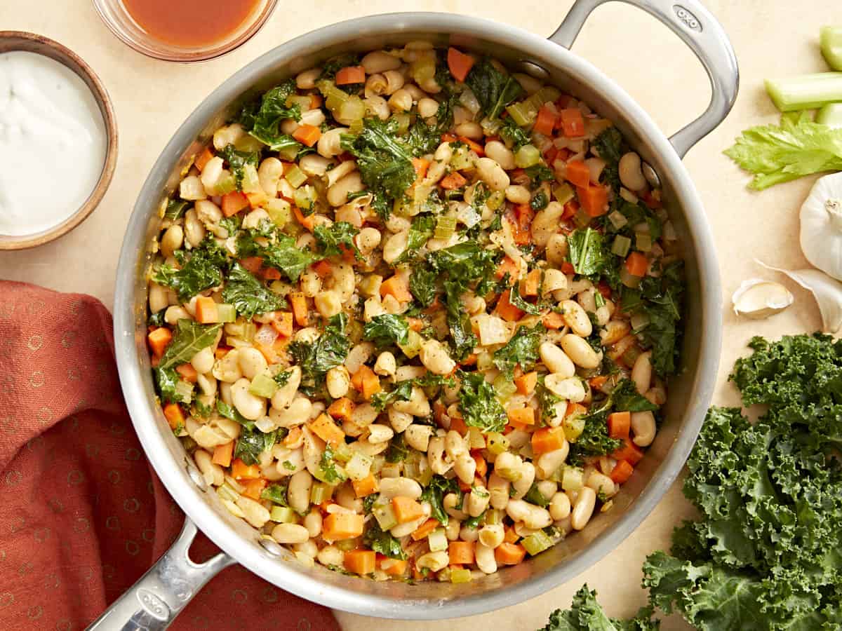 overhead view of buffalo beans and greens in a pan.