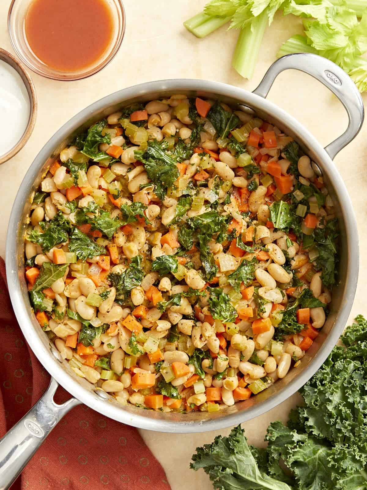 overhead view of buffalo beans and greens in a pan.