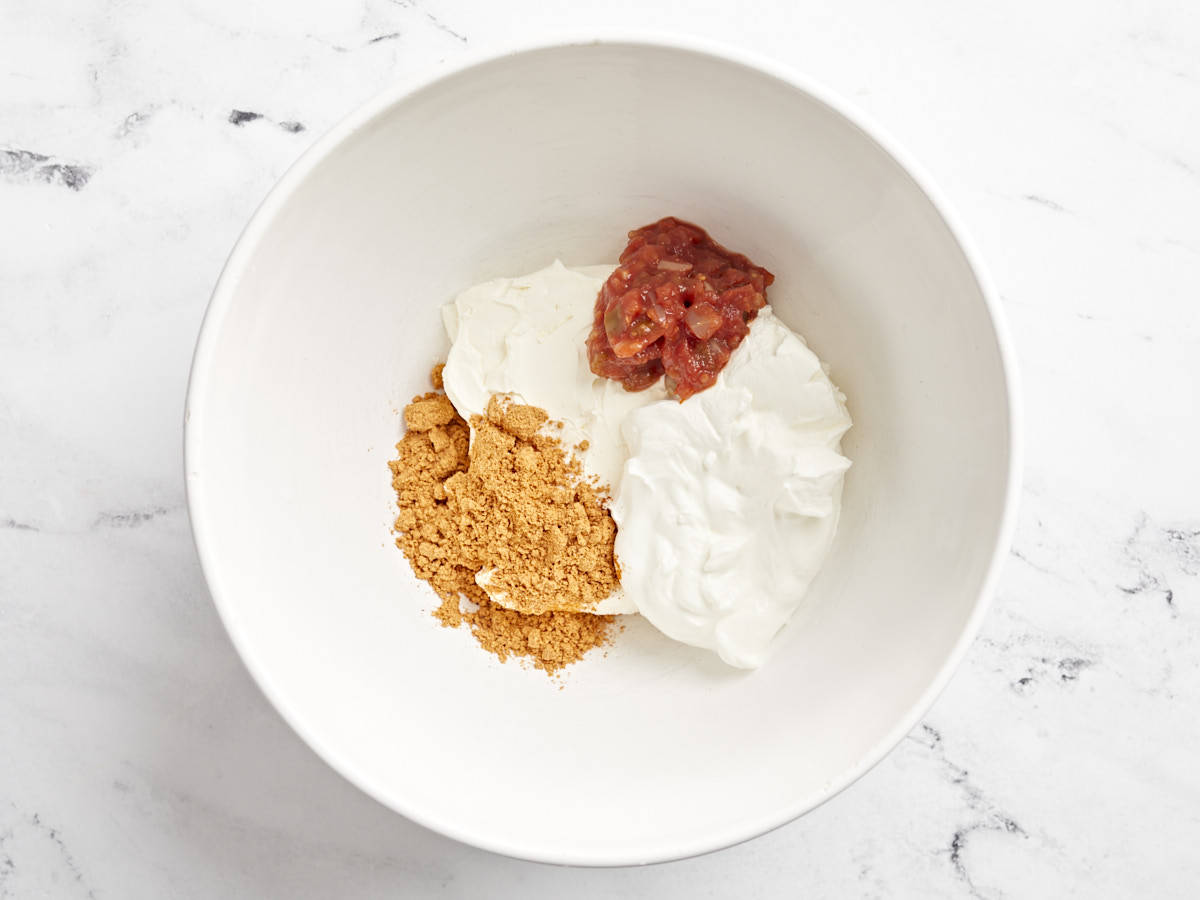 Taco Dip ingredients in a white bowl.