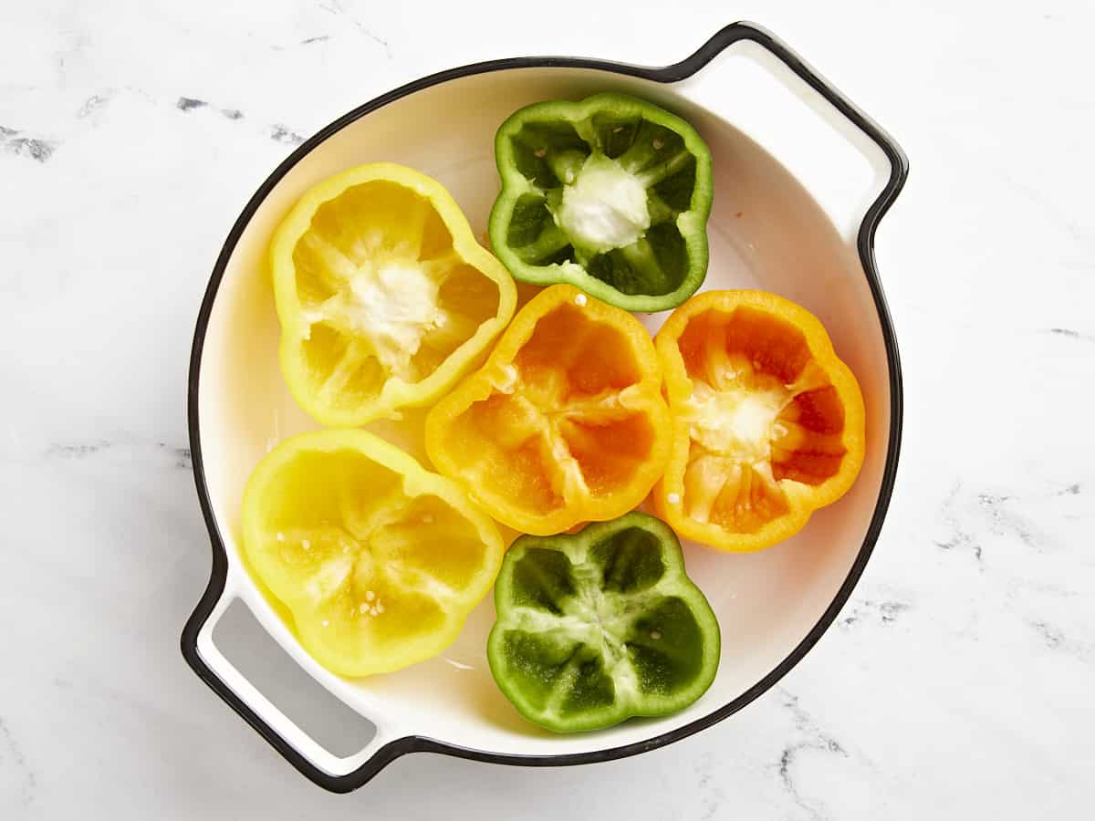 Prepped bell peppers in a baking dish. 