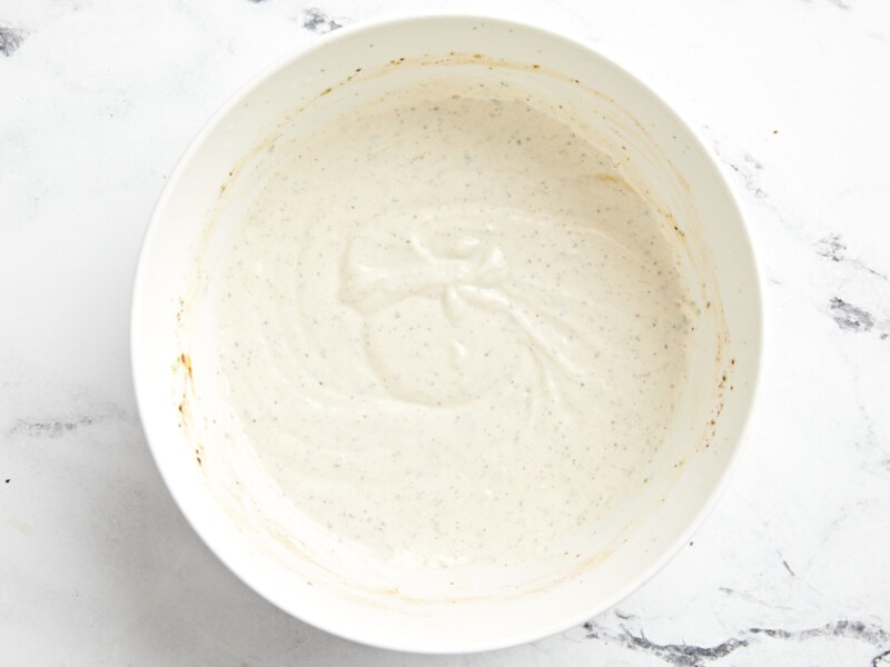 creamy white dressing in a white bowl.