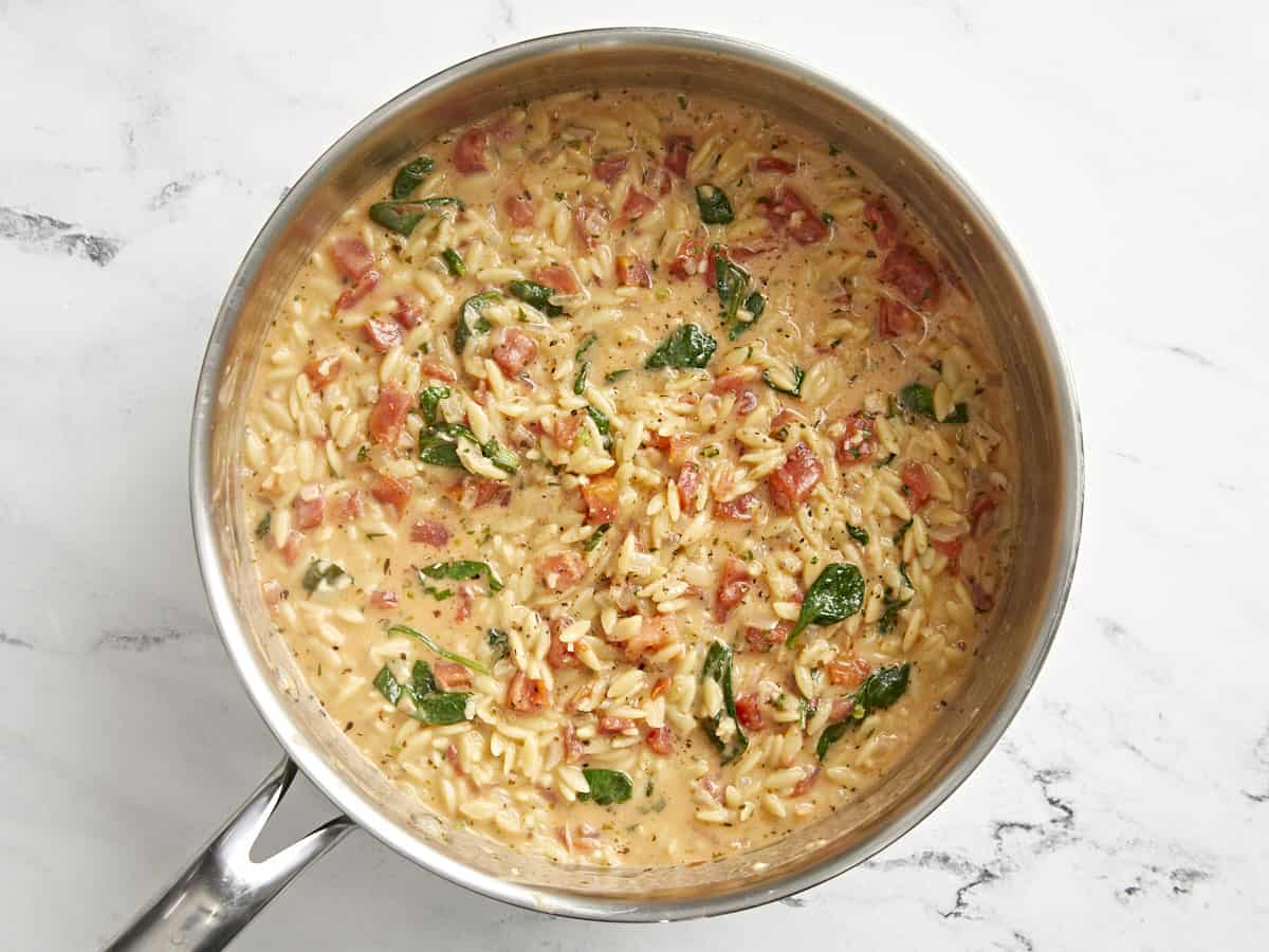 creamy tuscan orzo in a pan.