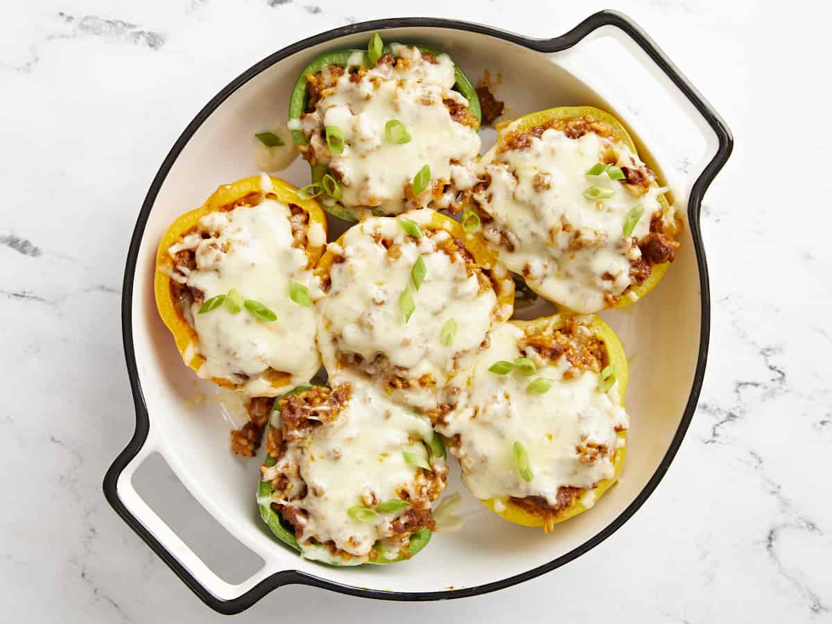 Finished stuffed bell peppers topped with sliced green onion.