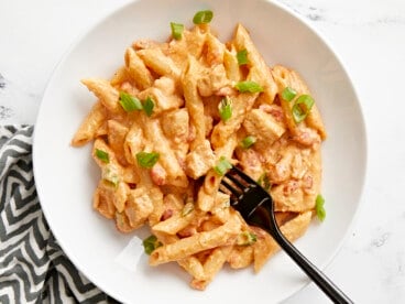 Overhead view of a bowl full of buffalo chicken pasta with a fork in the center.