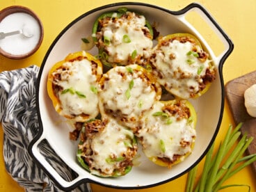 Overhead view of chorizo stuffed bell peppers in a round baking dish.