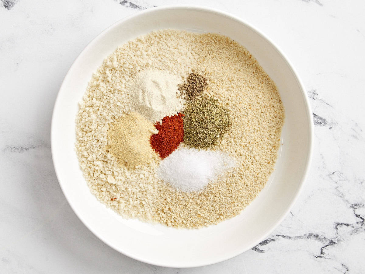 Overhead view of breadcrumbs and seasoning in a bowl.