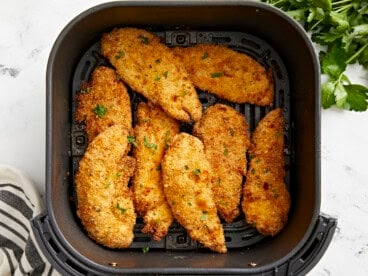 Basket of crispy chicken tenders from an air fryer.