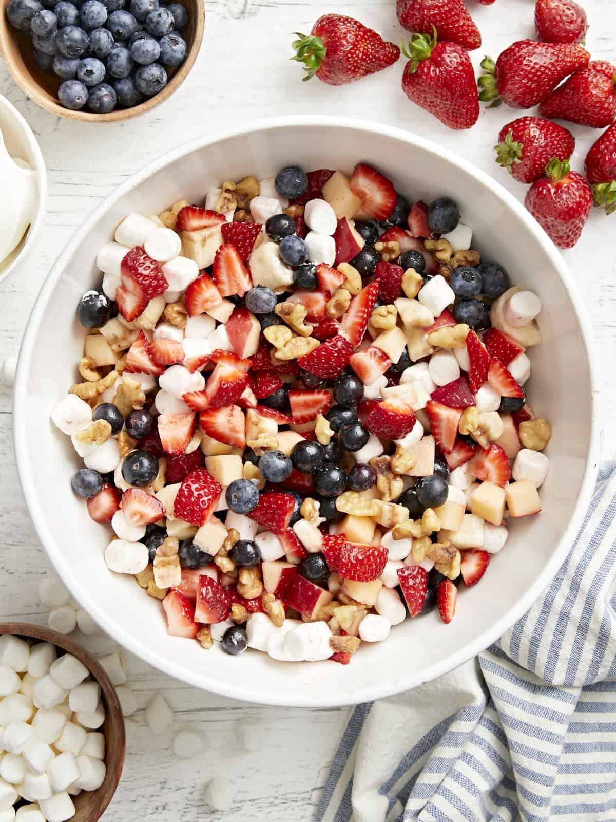 overhead view of a bowl of red white and blue fruit salad.